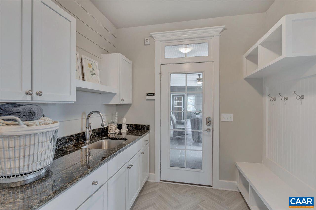 30 Portelet Road Crozet, VA 22932 - Photo 16 of 25 a kitchen with granite countertop a sink a stove and cabinets