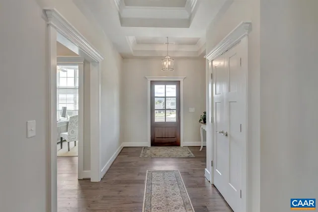 a view of a hallway with wooden floor and closet