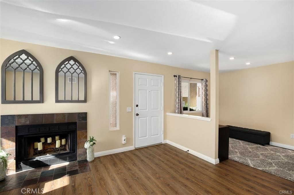 31909 Del Cielo, Unit 11 Bonsall, CA 92003 - Photo 4 of 16 a view of a livingroom with wooden floor and a fireplace