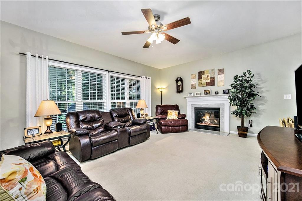 17005 Hampton Trace Road Huntersville, NC 28078 - Photo 14 of 40 a living room with furniture and a fireplace