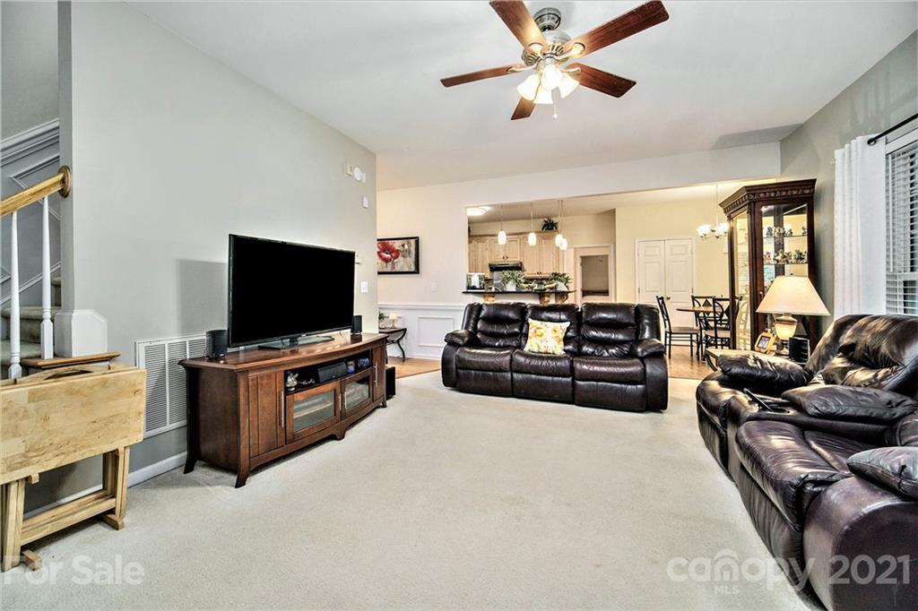 17005 Hampton Trace Road Huntersville, NC 28078 - Photo 16 of 40 a living room with furniture and a flat screen tv