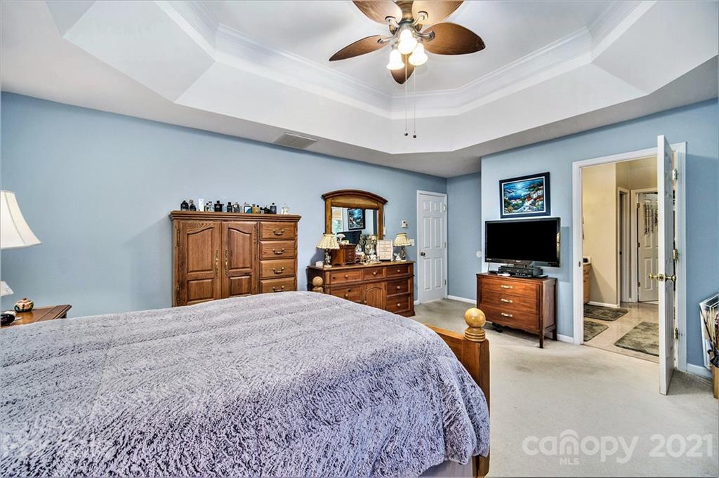 17005 Hampton Trace Road Huntersville, NC 28078 - Photo 19 of 40 a bedroom with a bed and a flat screen tv