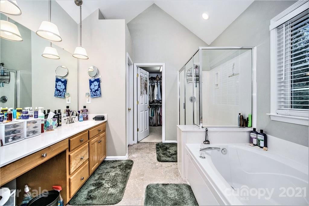 17005 Hampton Trace Road Huntersville, NC 28078 - Photo 20 of 40 a large bathroom with a tub sink double vanity granite and a large mirror