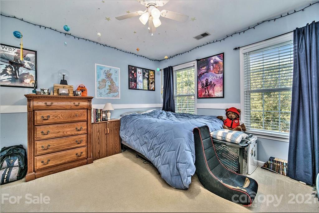 17005 Hampton Trace Road Huntersville, NC 28078 - Photo 25 of 40 a bed room with a bed and a chandelier