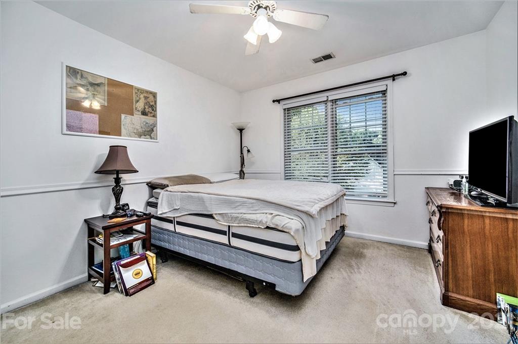 17005 Hampton Trace Road Huntersville, NC 28078 - Photo 26 of 40 a bedroom with a bed and a flat tv screen on the dresser