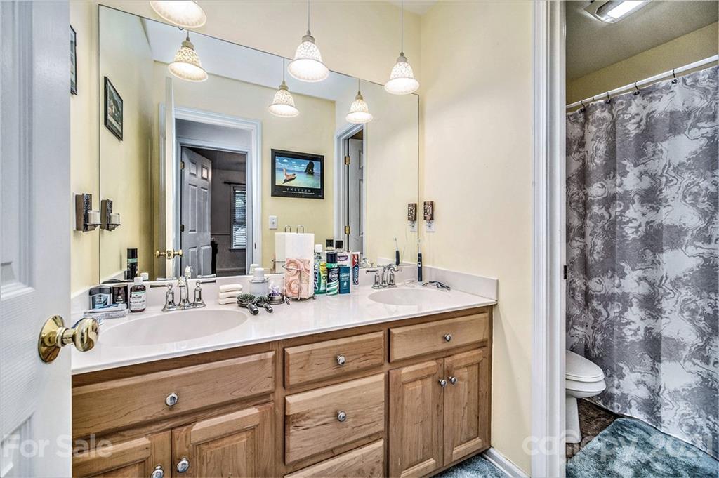 17005 Hampton Trace Road Huntersville, NC 28078 - Photo 27 of 40 a bathroom with a sink a toilet and a mirror