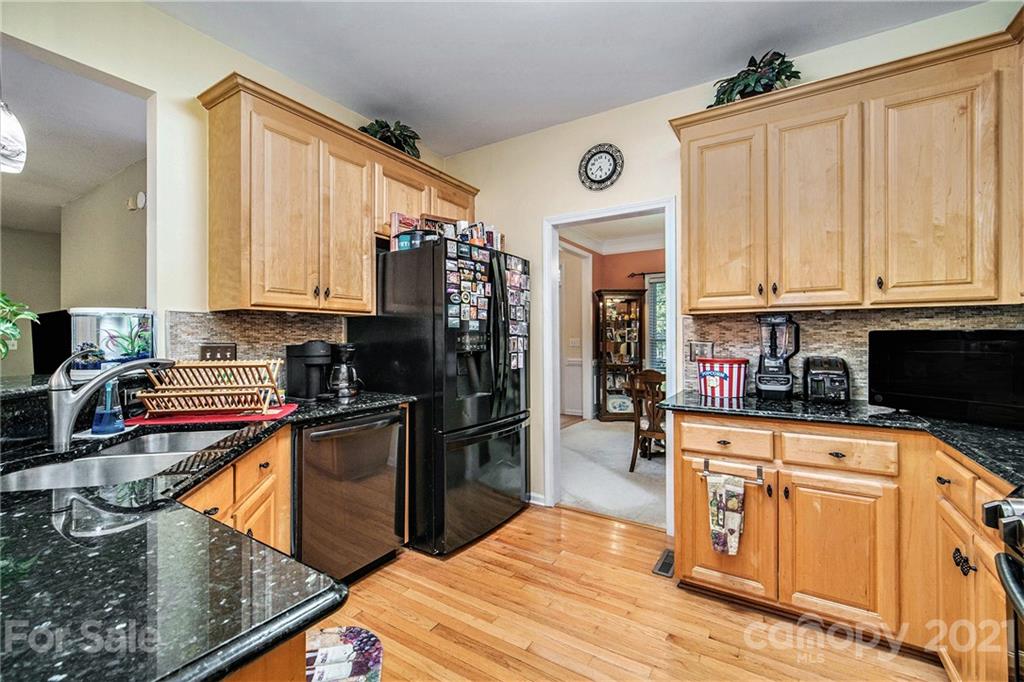 17005 Hampton Trace Road Huntersville, NC 28078 - Photo 7 of 40 a kitchen with stainless steel appliances granite countertop a refrigerator a stove top oven a sink and dishwasher