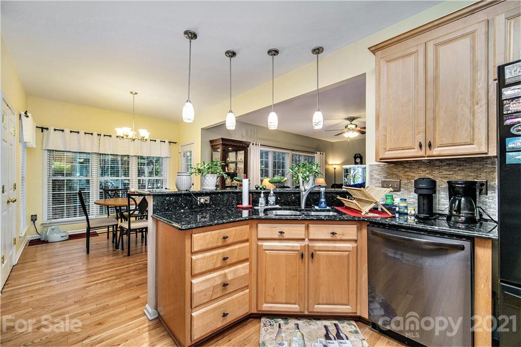 17005 Hampton Trace Road Huntersville, NC 28078 - Photo 10 of 40 a kitchen with stainless steel appliances granite countertop a stove and a wooden floors
