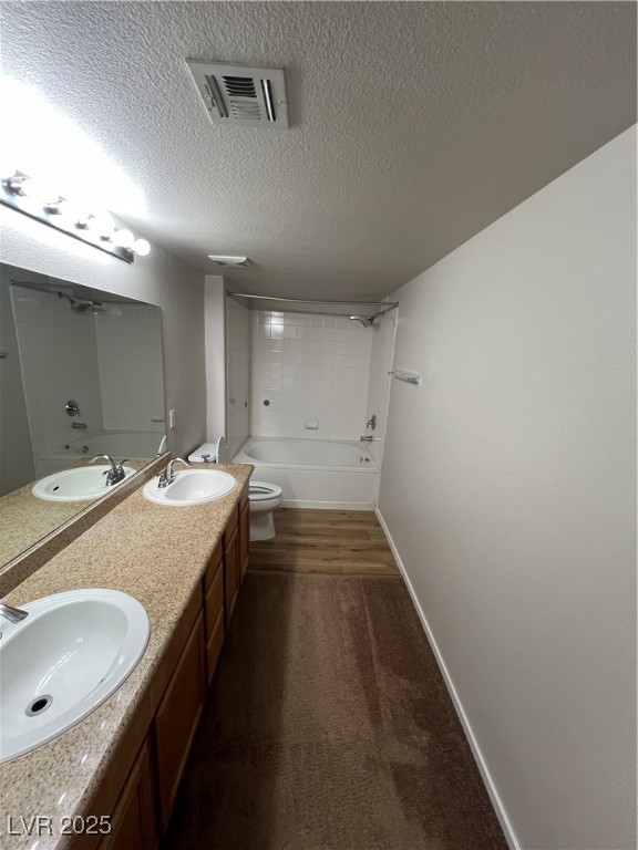 7255 West Sunset Road, Unit 2072 Las Vegas, NV 89113 - Photo 11 of 19 Bathroom featuring double vanity, bathing tub / shower combination, a textured ceiling, and dark colored carpet
