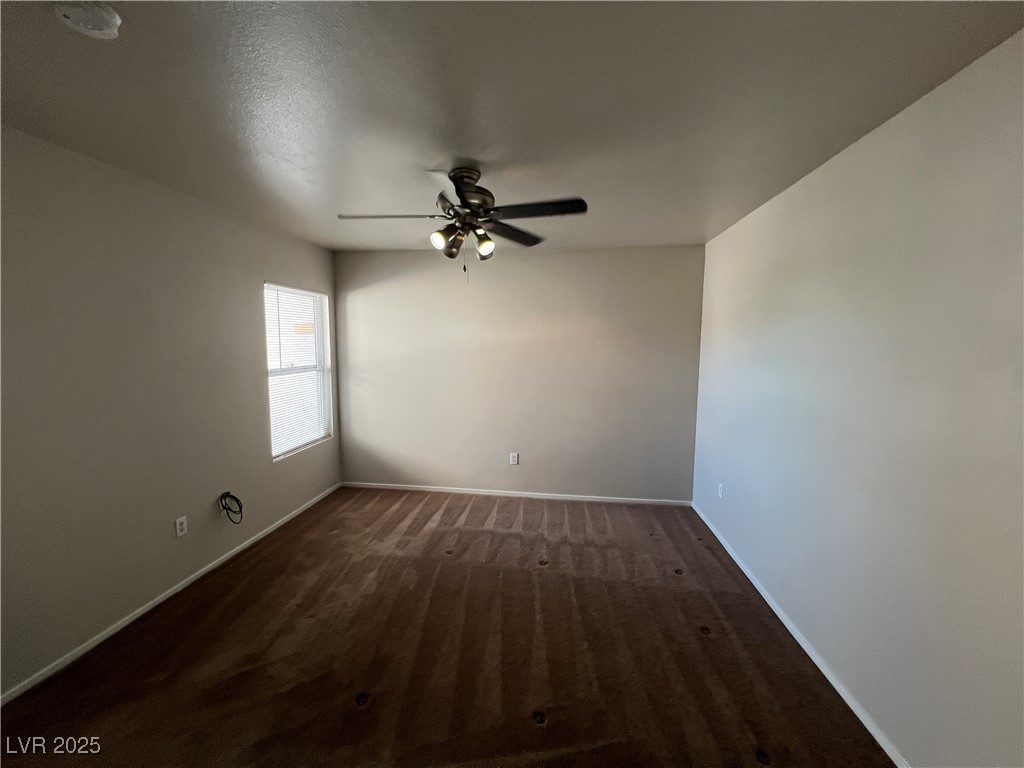 7255 West Sunset Road, Unit 2072 Las Vegas, NV 89113 - Photo 12 of 19 Unfurnished room with dark carpet and a ceiling fan