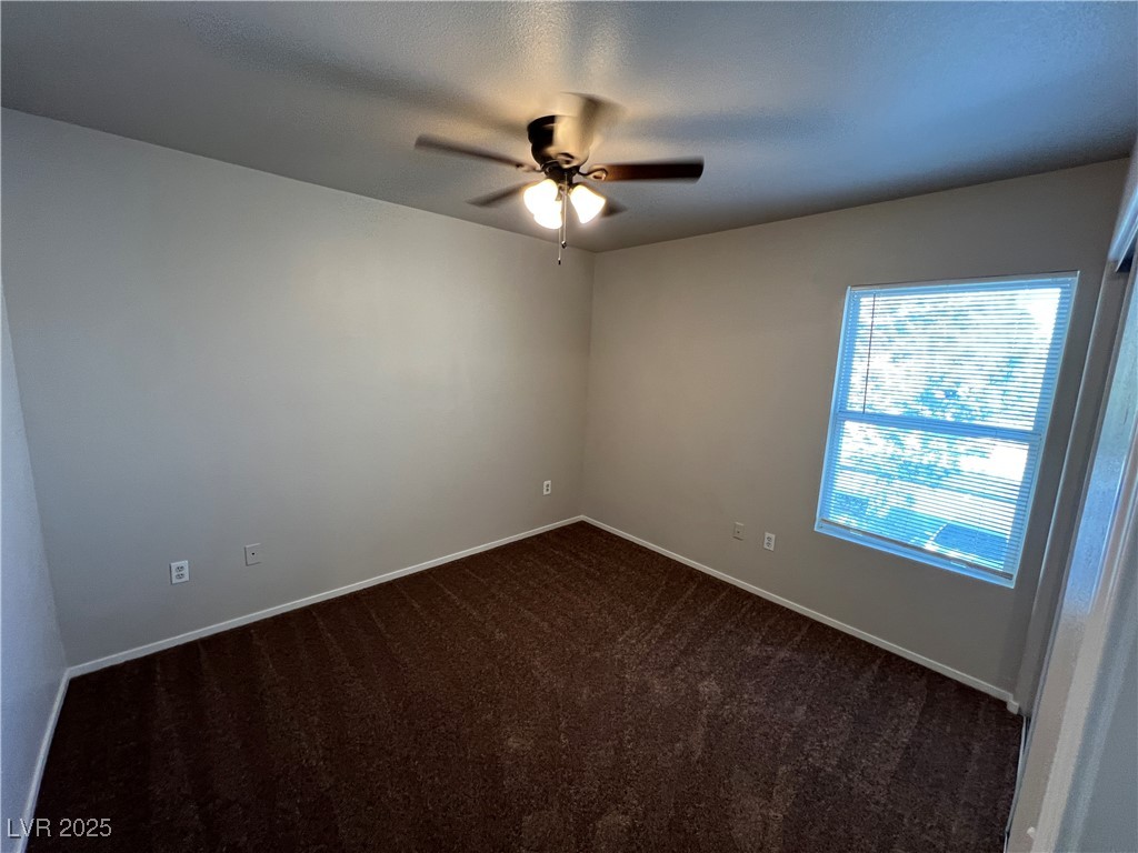 7255 West Sunset Road, Unit 2072 Las Vegas, NV 89113 - Photo 4 of 19 Empty room featuring dark colored carpet, a ceiling fan, and a textured ceiling