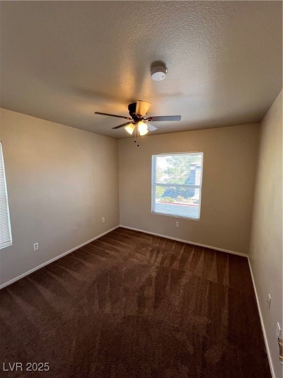 7255 West Sunset Road, Unit 2072 Las Vegas, NV 89113 - Photo 5 of 19 Empty room featuring dark colored carpet, a textured ceiling, ceiling fan, and a smoke detector