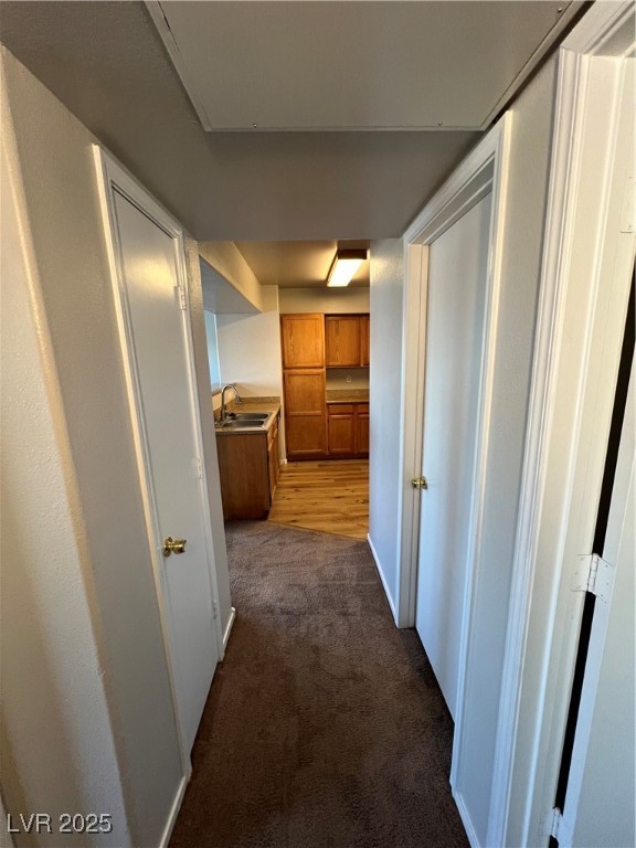 7255 West Sunset Road, Unit 2072 Las Vegas, NV 89113 - Photo 6 of 19 Hall with dark carpet and a sink