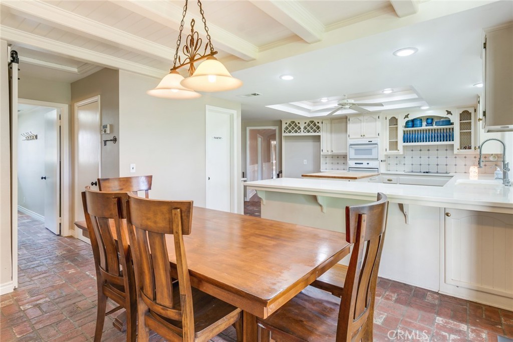 7770 Broadacre Place Riverside, CA 92504 - Photo 13 of 42 a view of a dining room and a kitchen with a table chairs