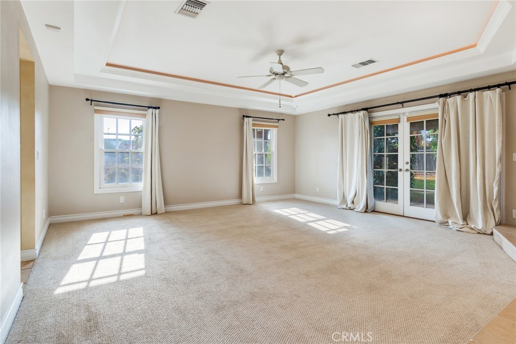 7770 Broadacre Place Riverside, CA 92504 - Photo 14 of 42 an empty room with windows and fan
