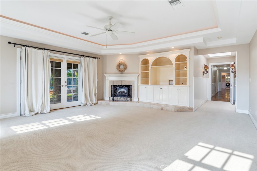 7770 Broadacre Place Riverside, CA 92504 - Photo 15 of 42 a view of an empty room with a fireplace and a window