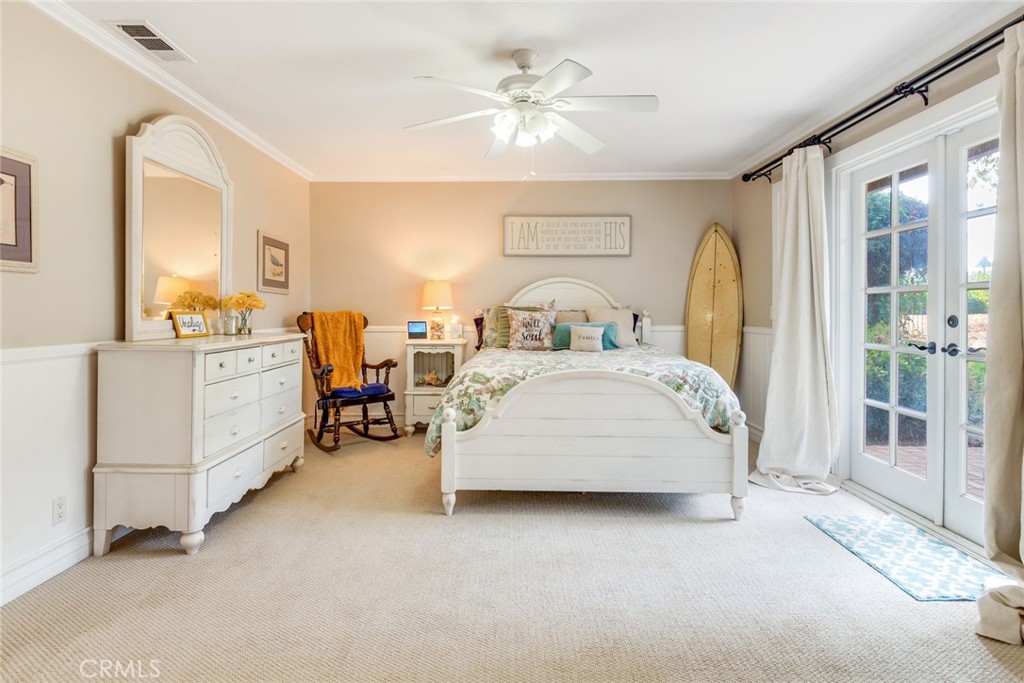 7770 Broadacre Place Riverside, CA 92504 - Photo 19 of 42 a spacious bedroom with a bed a table and chair