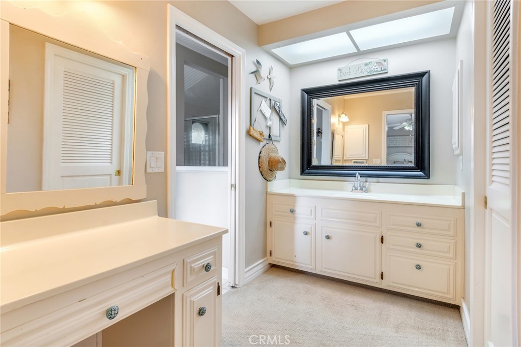 7770 Broadacre Place Riverside, CA 92504 - Photo 20 of 42 a bathroom with a sink a vanity and a mirror