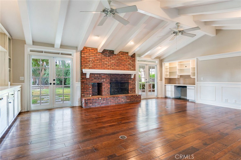 7770 Broadacre Place Riverside, CA 92504 - Photo 7 of 42 an empty room with wooden floor fireplace and windows