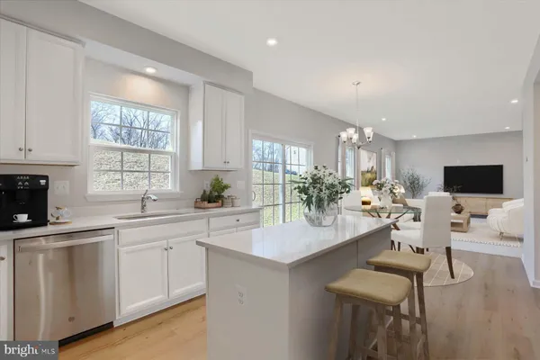 a large kitchen with kitchen island a sink stainless steel appliances and cabinets