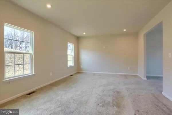 a view of a big room with kitchen and windows