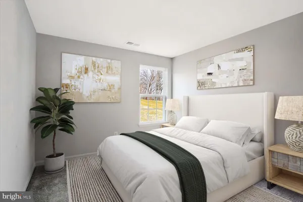 a bedroom with a large bed a mirror and a flat tv screen