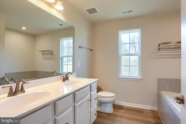 a white bath tub sitting next to a shower