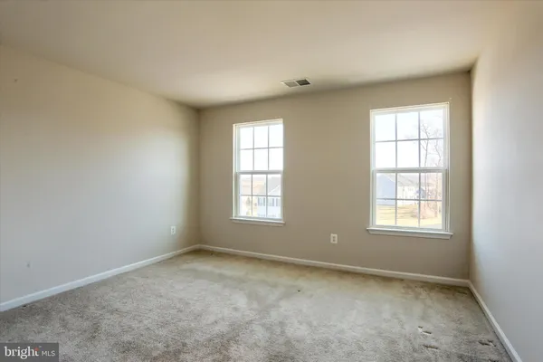 a view of an empty room and closet area