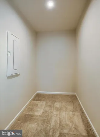 an empty room with windows and ceiling fan