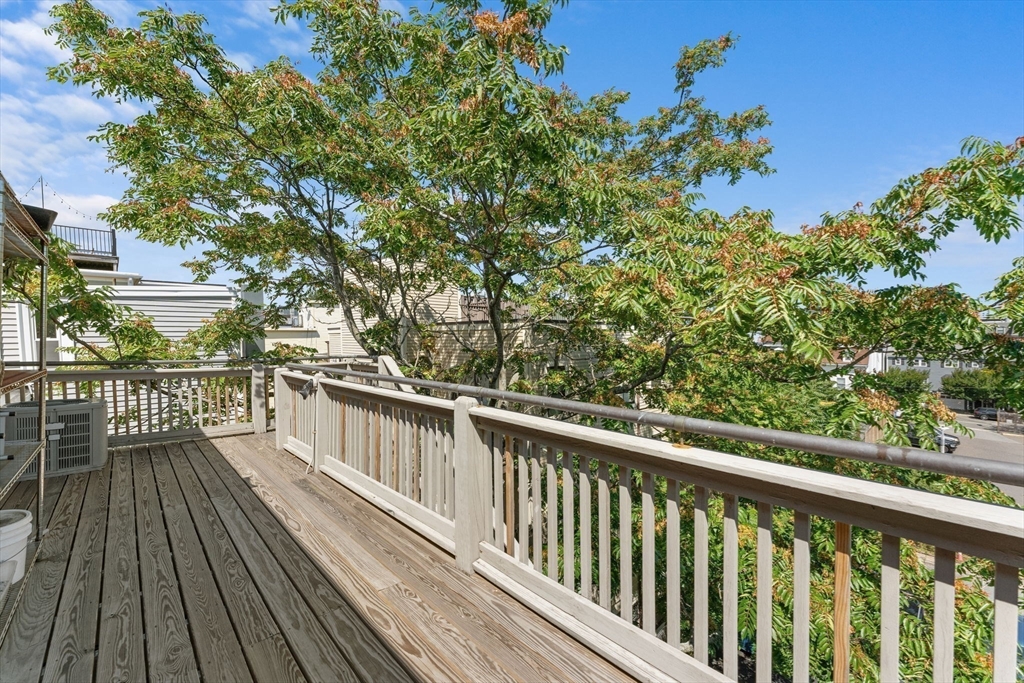 262-264 West Broadway Boston, MA 02127 - Photo 13 of 22 a view of balcony with wooden floor and fence