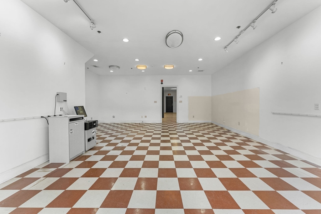 262-264 West Broadway Boston, MA 02127 - Photo 4 of 22 a view of a big room with a black white checkered floor and a refrigerator
