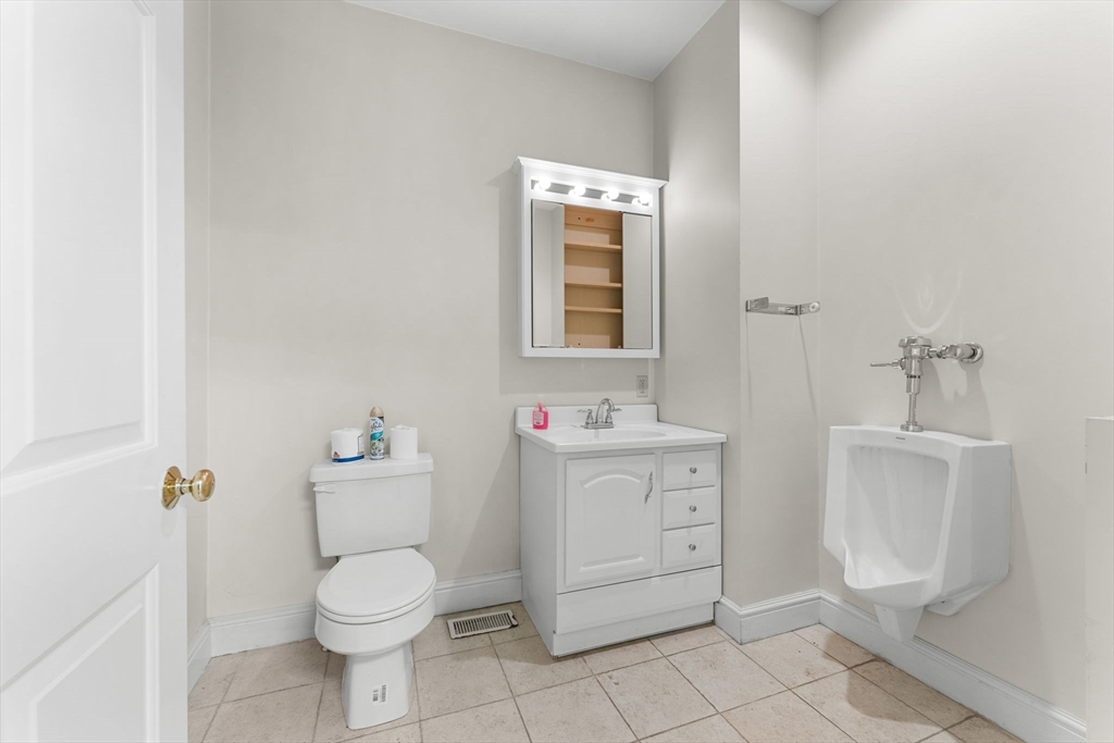 262-264 West Broadway Boston, MA 02127 - Photo 6 of 22 a bathroom with a toilet sink and mirror