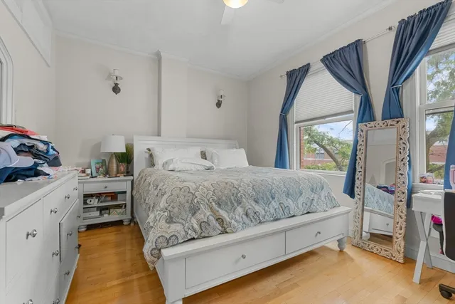 a spacious bedroom with a bed and a large window