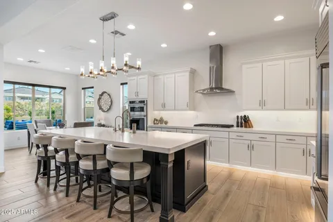 a large kitchen with kitchen island a dining table and chairs