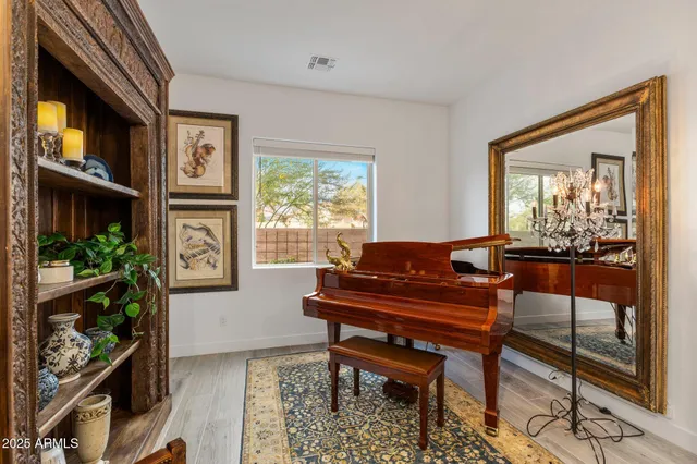 a living room with furniture a flat screen tv and a floor to ceiling window