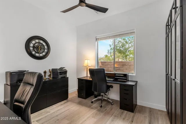 a view of a workspace with furniture and a window