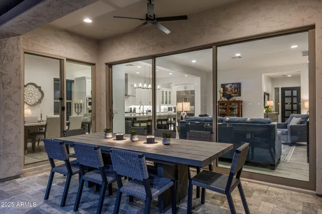 a dining room with furniture a chandelier and window