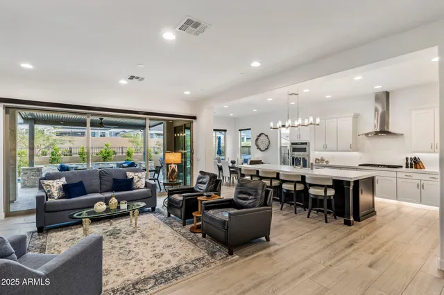 a living room with lots of furniture and kitchen view