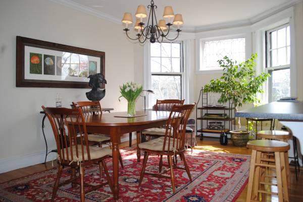 a view of a dining room with furniture a chandelier and wooden floor