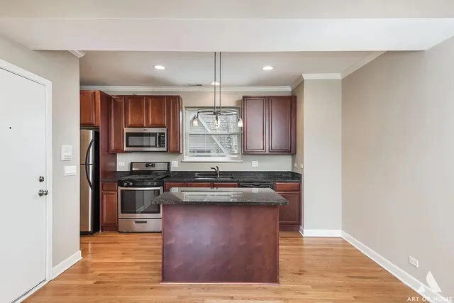 a kitchen with stainless steel appliances granite countertop a sink stove and refrigerator