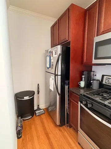 a kitchen with a refrigerator and a stove top oven