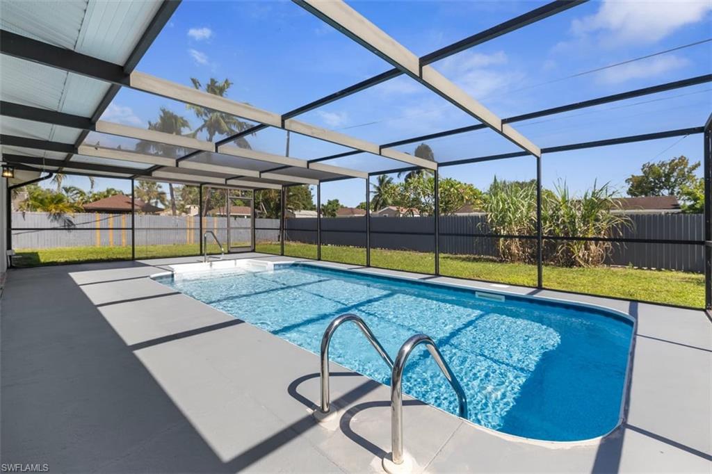 View of swimming pool with a fenced backyard, a lanai, a patio area, and a sunroom