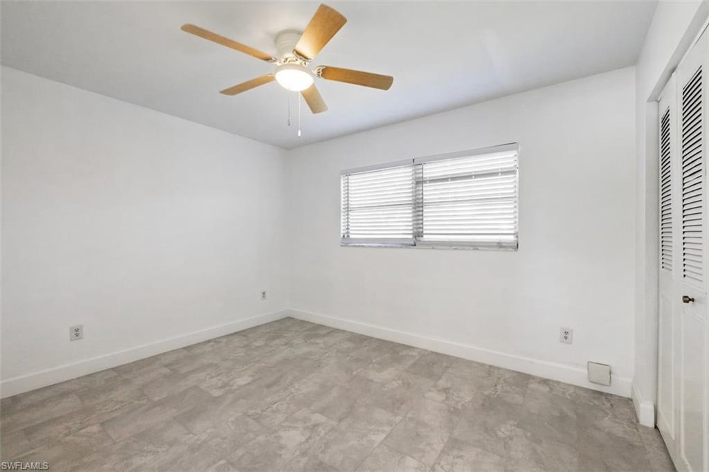 1948 46th Street Southwest Naples, FL 34116 - Photo 15 of 42 Unfurnished bedroom featuring a closet and ceiling fan