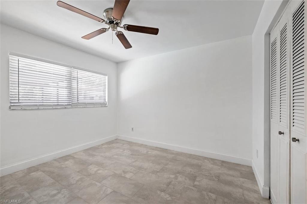 1948 46th Street Southwest Naples, FL 34116 - Photo 17 of 42 Unfurnished bedroom featuring a closet and a ceiling fan