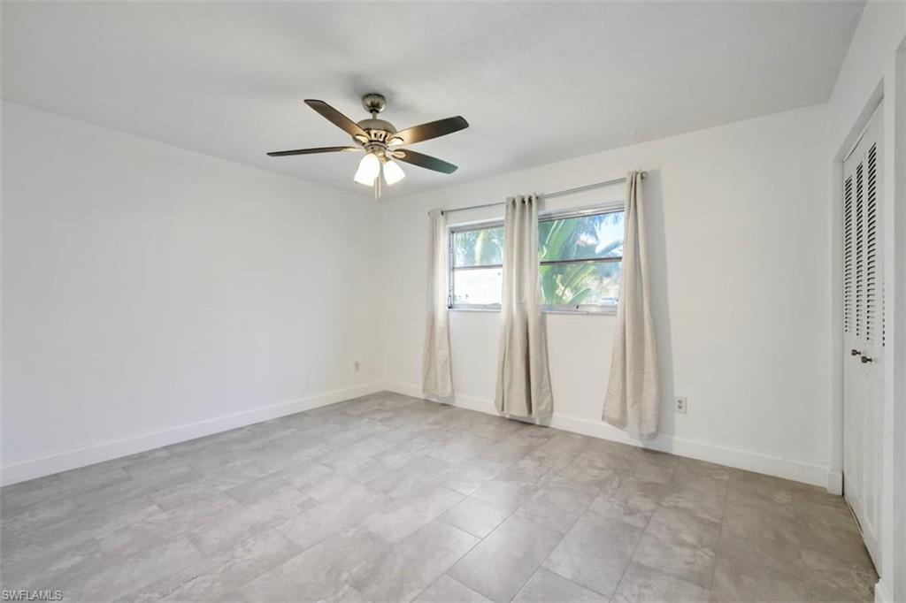 1948 46th Street Southwest Naples, FL 34116 - Photo 18 of 42 Unfurnished bedroom featuring ceiling fan and a closet