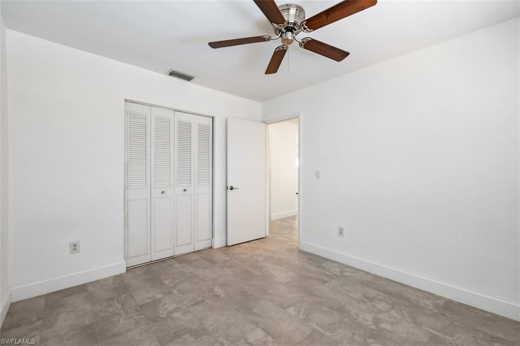 1948 46th Street Southwest Naples, FL 34116 - Photo 19 of 42 Unfurnished bedroom with a closet and ceiling fan