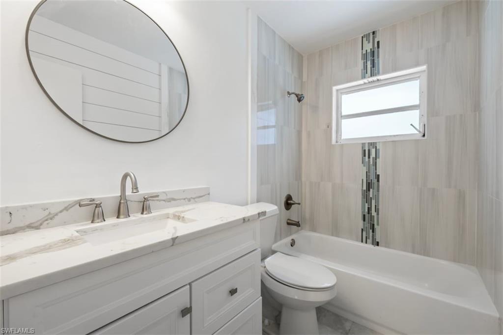 1948 46th Street Southwest Naples, FL 34116 - Photo 20 of 42 Full bathroom featuring tub / shower combination and vanity