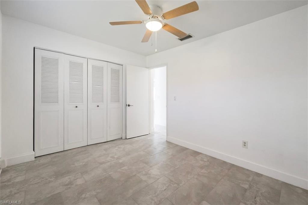 1948 46th Street Southwest Naples, FL 34116 - Photo 22 of 42 Unfurnished bedroom featuring a closet and ceiling fan