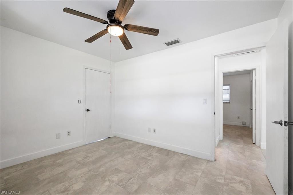 1948 46th Street Southwest Naples, FL 34116 - Photo 25 of 42 Empty room with ceiling fan and baseboards