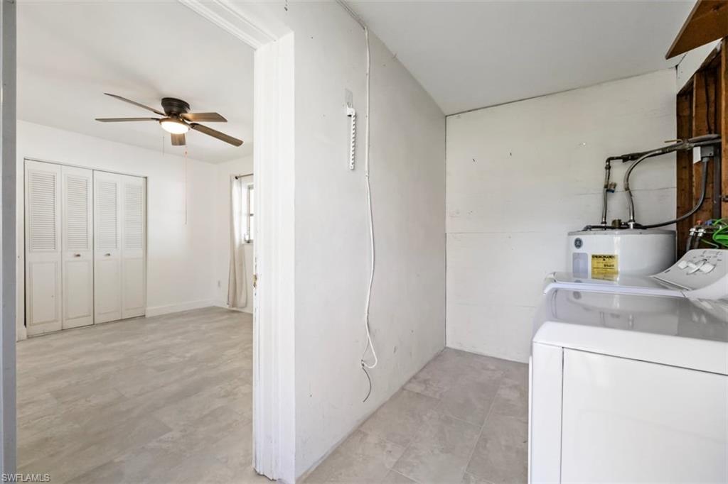 1948 46th Street Southwest Naples, FL 34116 - Photo 28 of 42 Laundry room with washing machine and dryer, electric water heater, a ceiling fan, and concrete floors